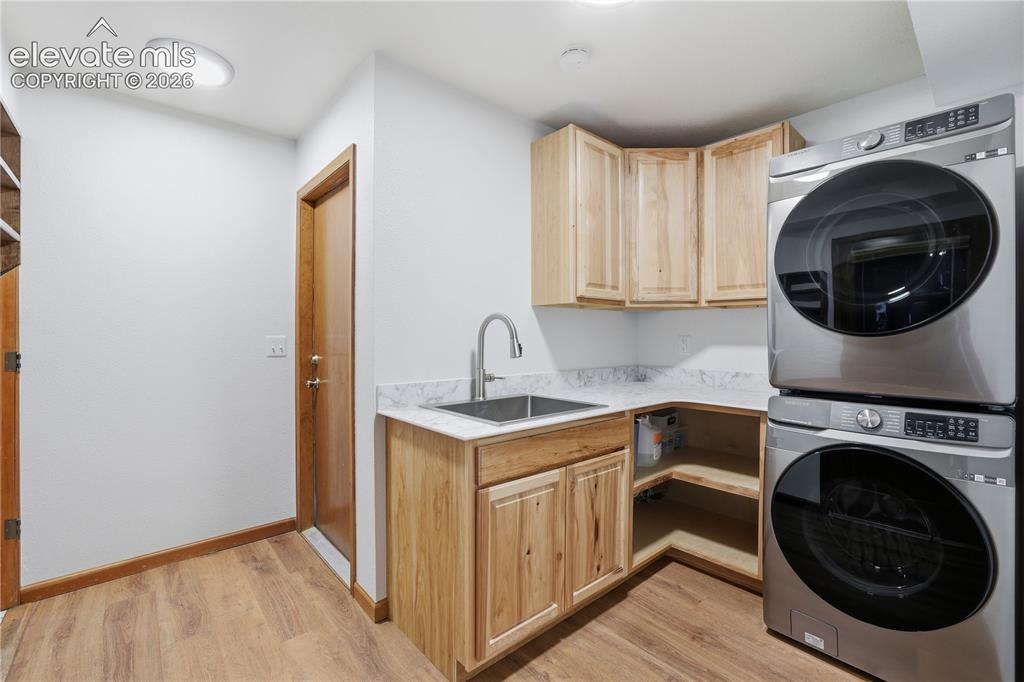 18190 Forest View Road Monument, CO 80132 - Photo 25 of 50 a kitchen with a washer and dryer in it