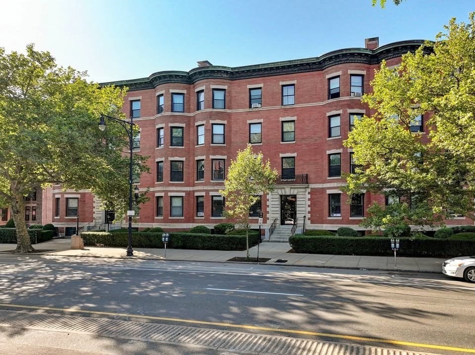 1064 Beacon Street, Unit 9 Brookline, MA 02446 - Photo 1 of 19 a front view of a residential apartment building with a yard