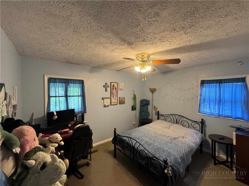36 Larkspur Road Newland, NC 28657 - Photo 16 of 36 a bedroom with a bed and a chandelier