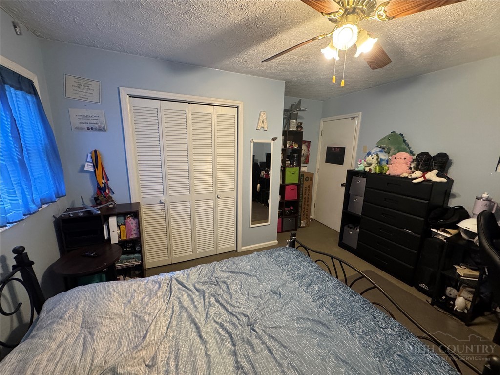 36 Larkspur Road Newland, NC 28657 - Photo 18 of 36 a bedroom with a bed and a chandelier