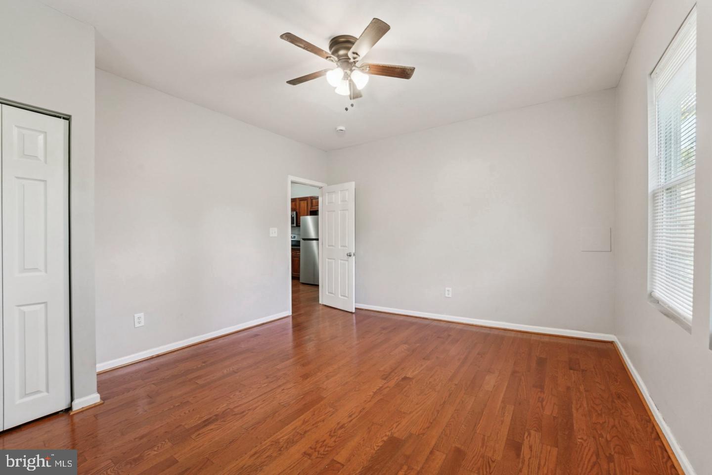 4511 Prospect Circle Baltimore, MD 21216 - Photo 12 of 25 an empty room with wooden floor and windows