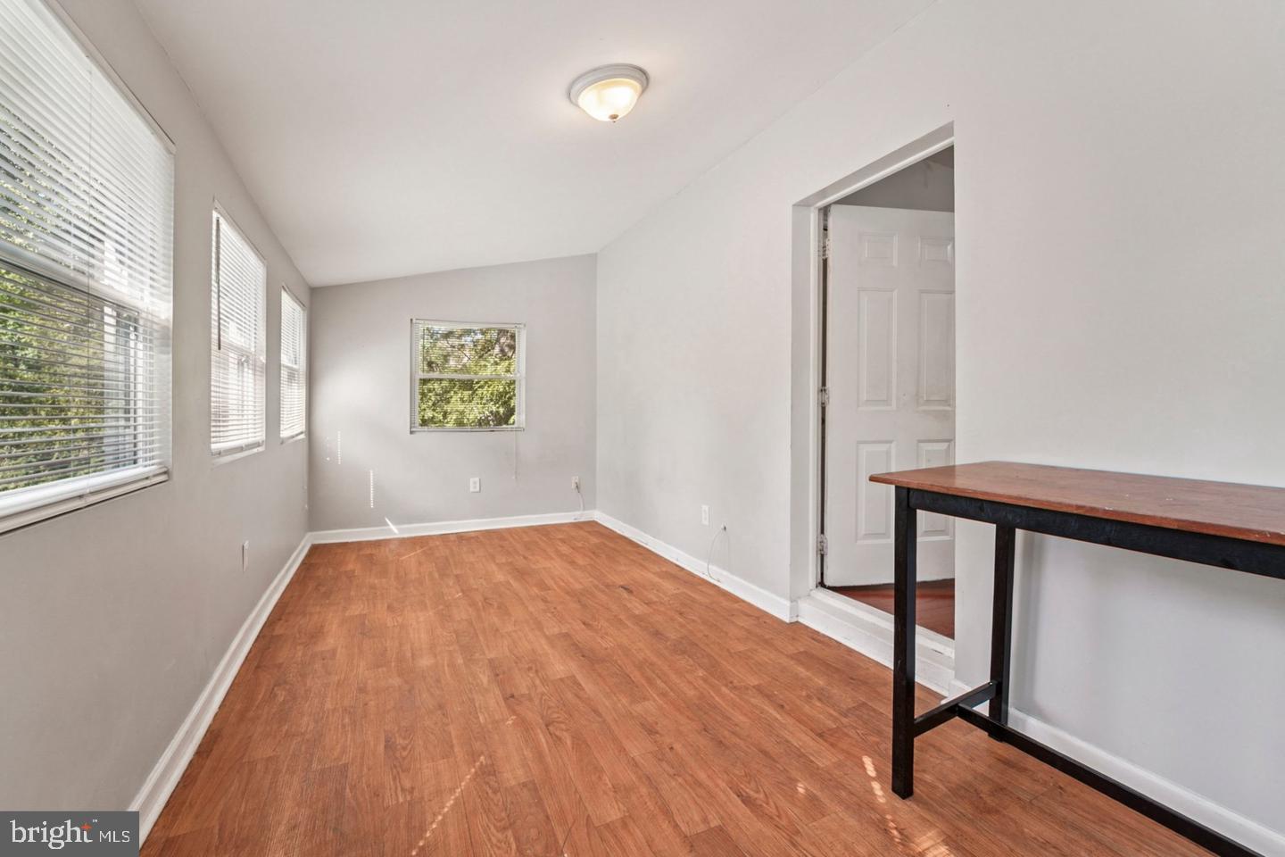 4511 Prospect Circle Baltimore, MD 21216 - Photo 14 of 25 a view of empty room with windows and wooden floor