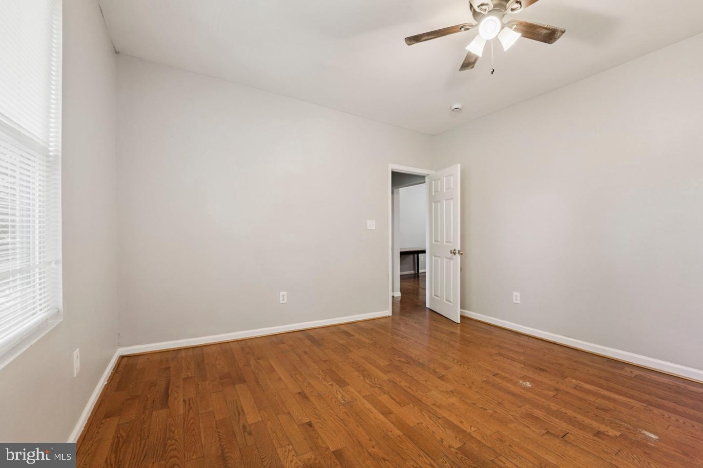 4511 Prospect Circle Baltimore, MD 21216 - Photo 20 of 25 wooden floor in an empty room with a window