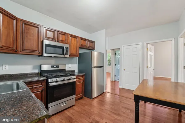a kitchen with stainless steel appliances a stove a microwave and a refrigerator