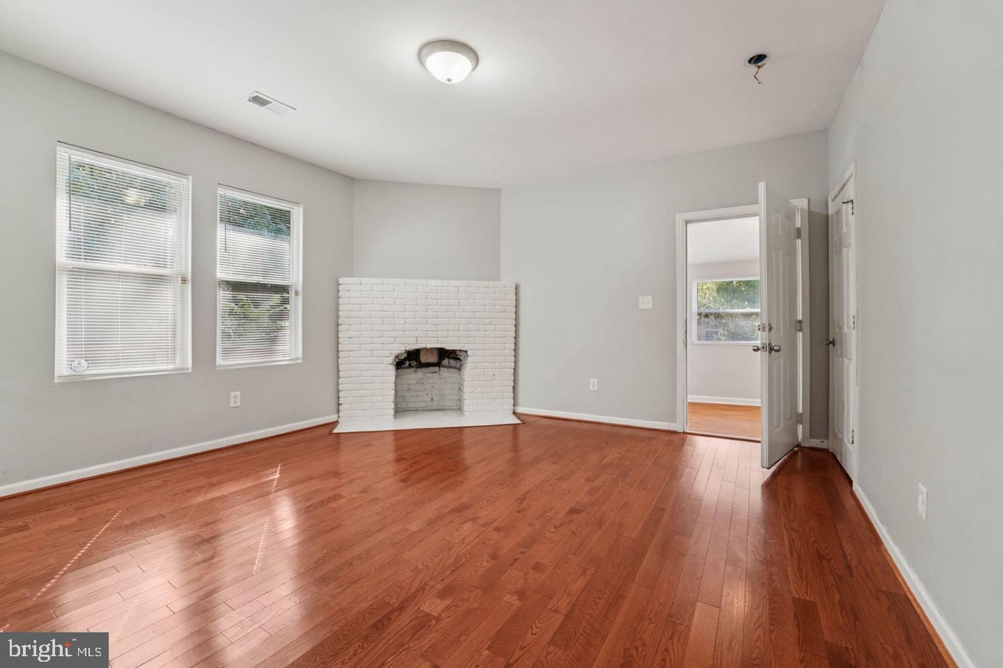 4511 Prospect Circle Baltimore, MD 21216 - Photo 10 of 25 a view of an empty room with window and wooden floor