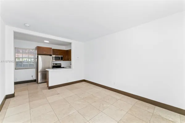 a view of kitchen with refrigerator and window