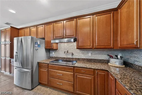 a kitchen with stainless steel appliances granite countertop a refrigerator and a sink