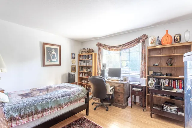 a bedroom with a bed and a book shelf