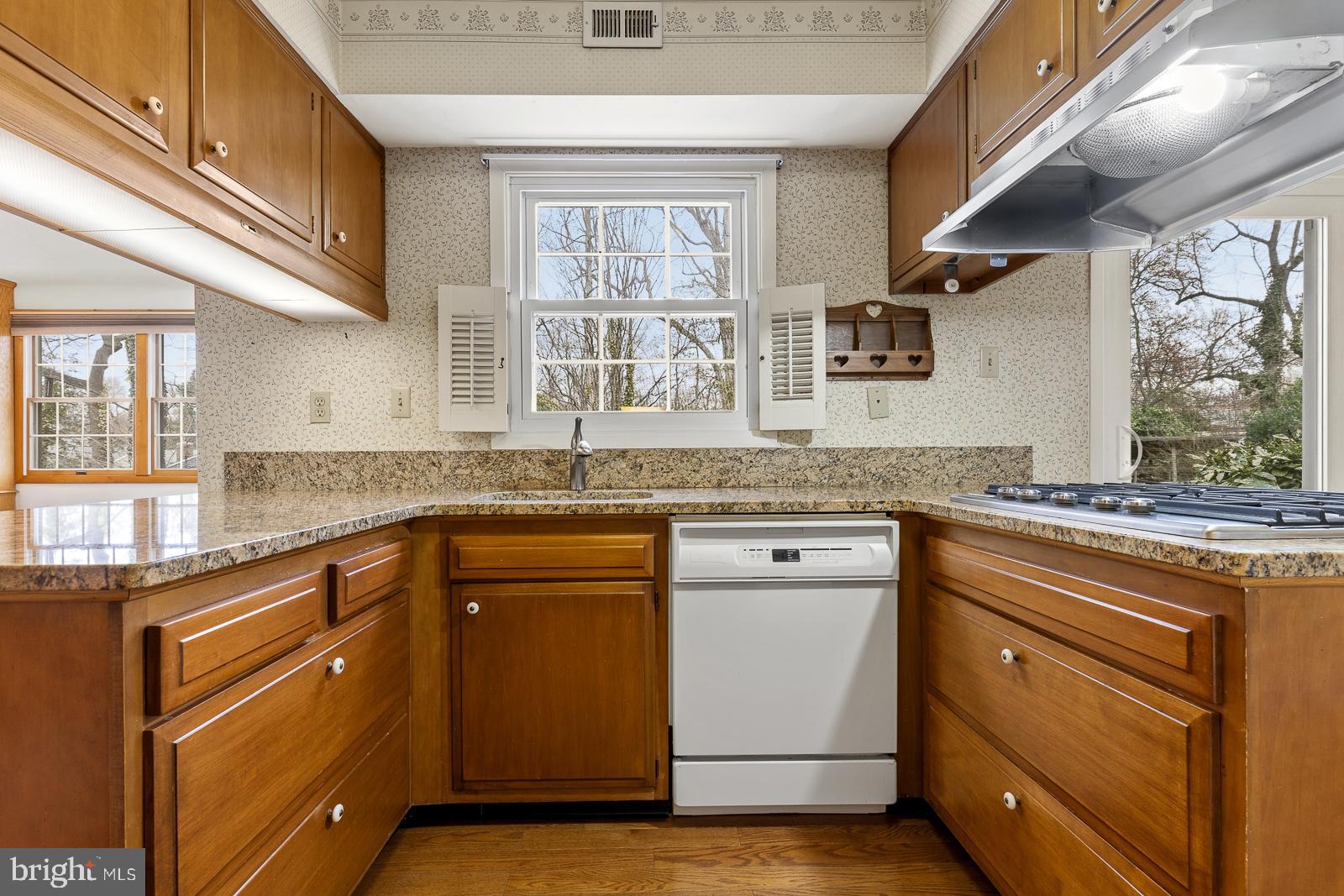 8714 Granite Lane Laurel, MD 20708 - Photo 15 of 35 a kitchen with granite countertop stainless steel appliances a sink stove and cabinets