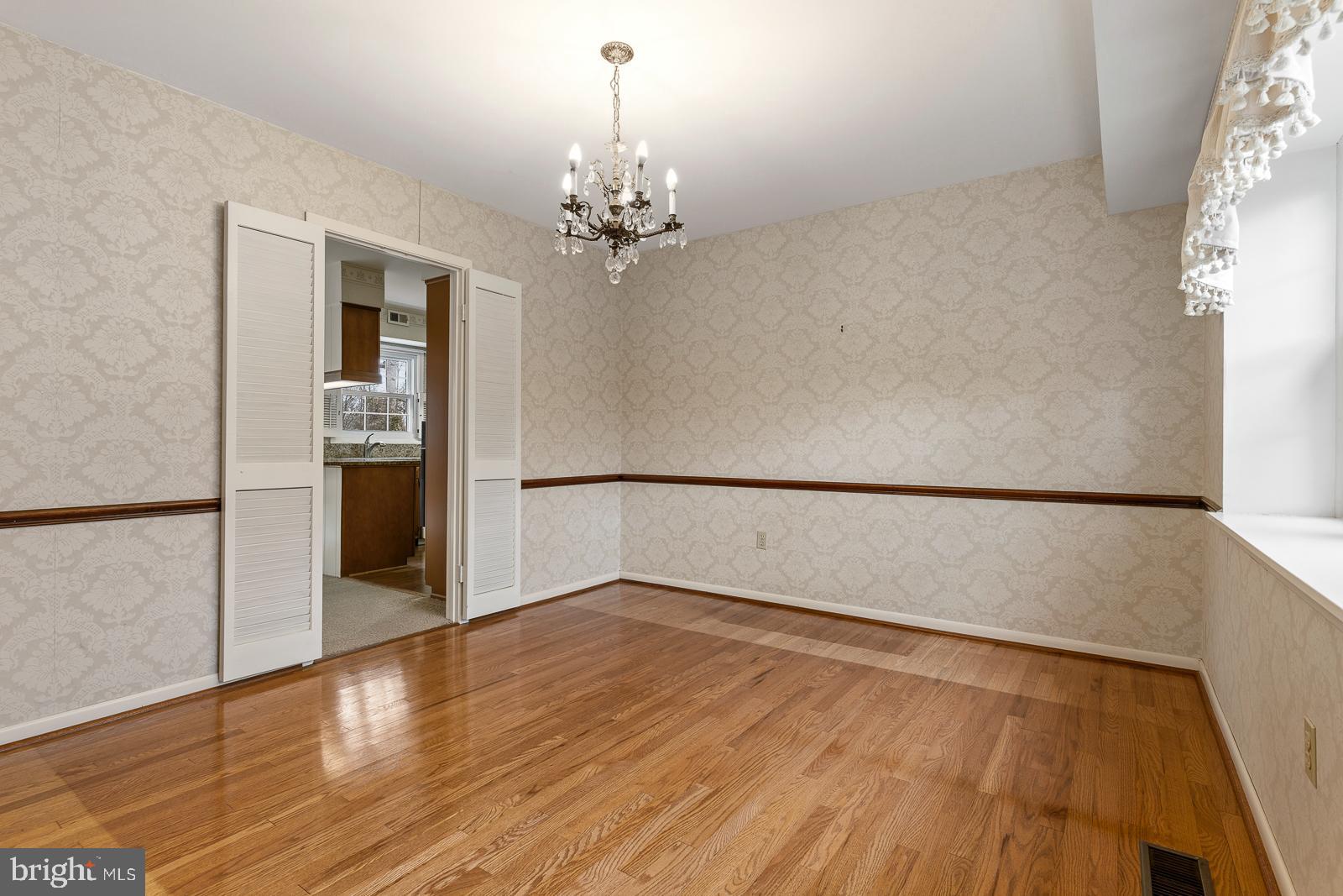 8714 Granite Lane Laurel, MD 20708 - Photo 10 of 35 a view of empty room with wooden floor and kitchen
