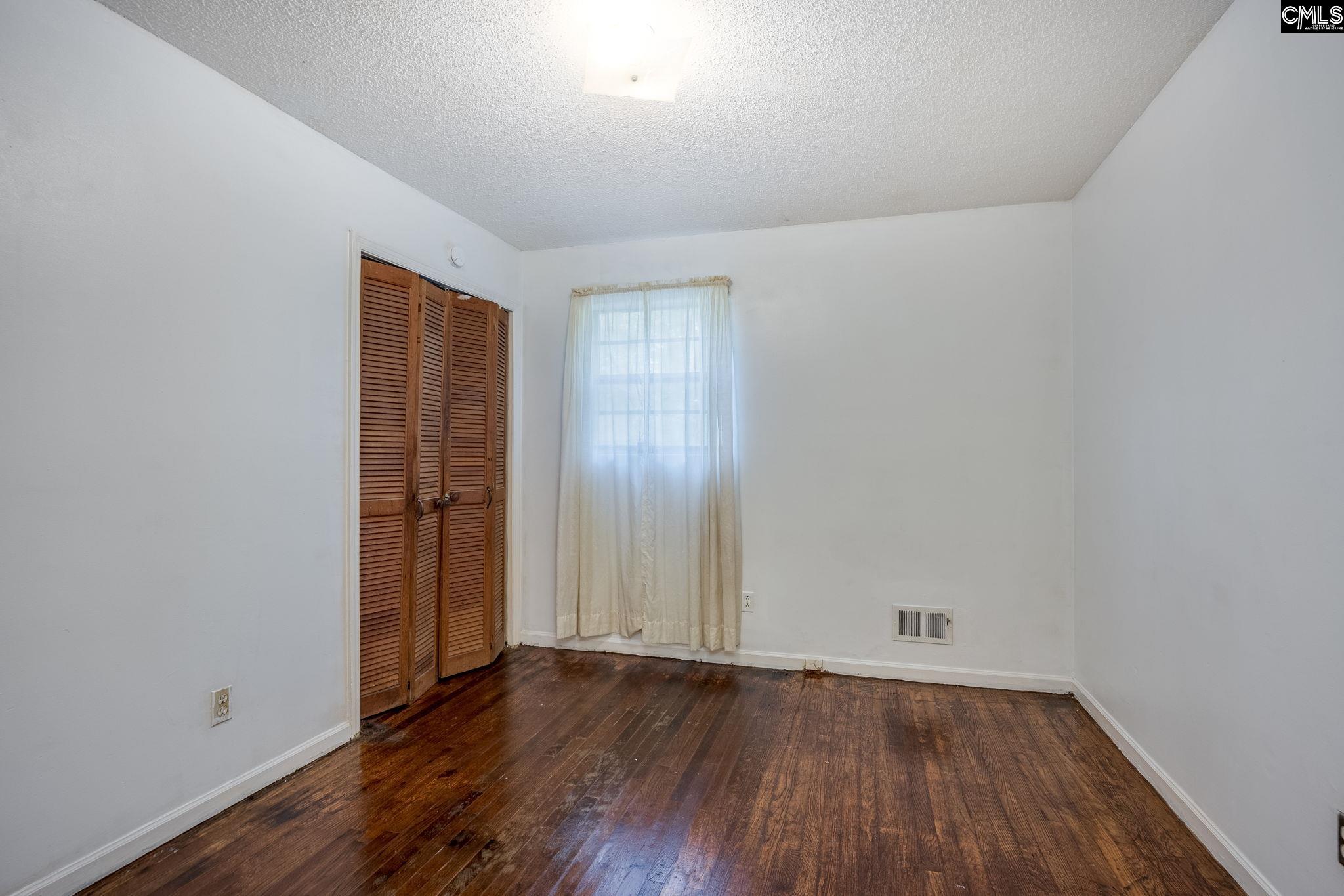 5666 Middleton Court Columbia, SC 29203 - Photo 29 of 42 an empty room with wooden floor and windows