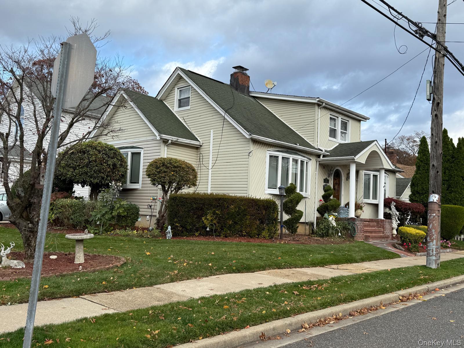 183 North Cottage Street Valley Stream, NY 11580 - Photo 2 of 16 Traditional-style home featuring a chimney, roof with shingles, and a front yard