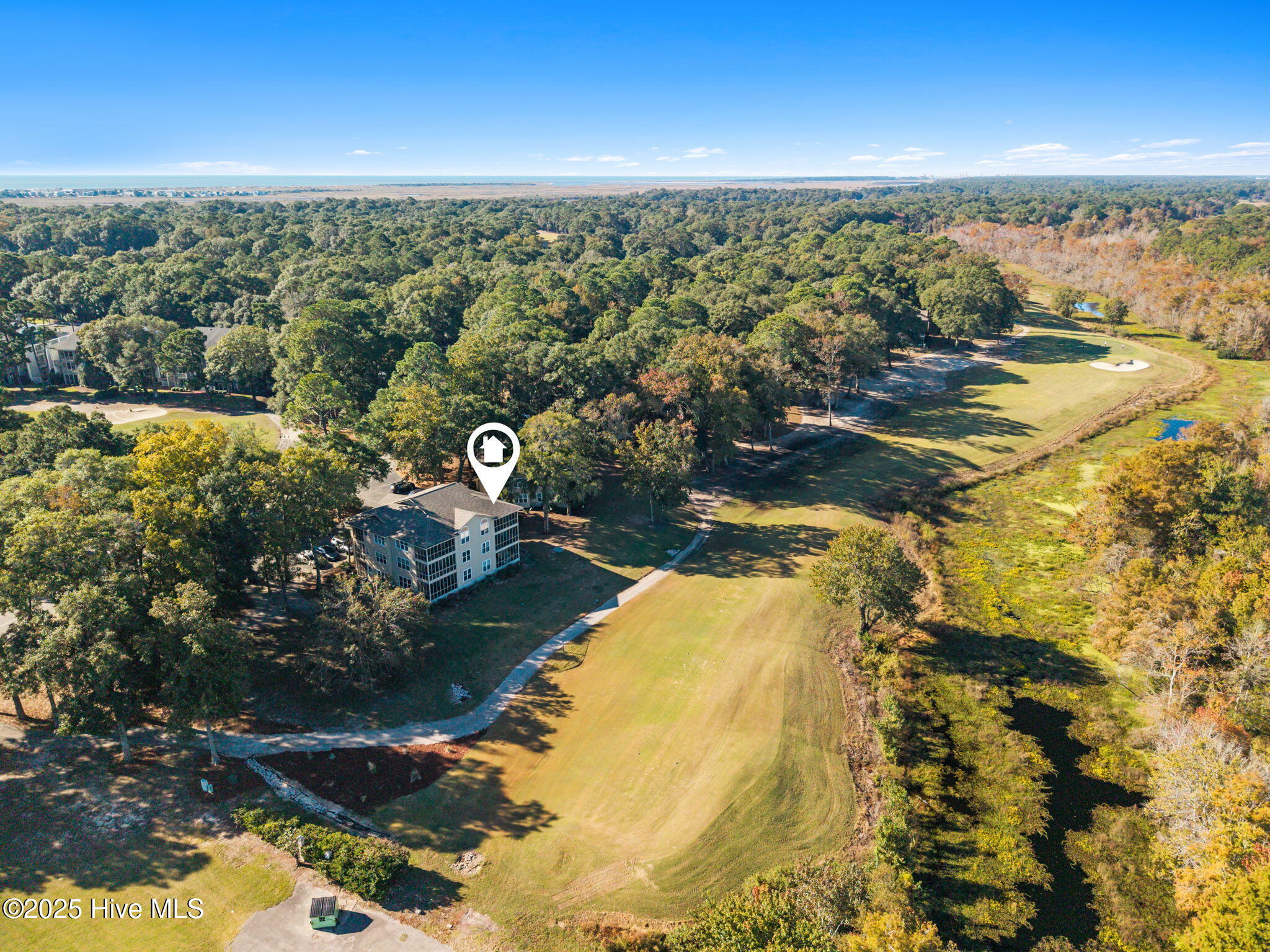 213 Clubhouse Road, Unit 105 Sunset Beach, NC 28468 - Photo 27 of 36 aerial back with golf fairway