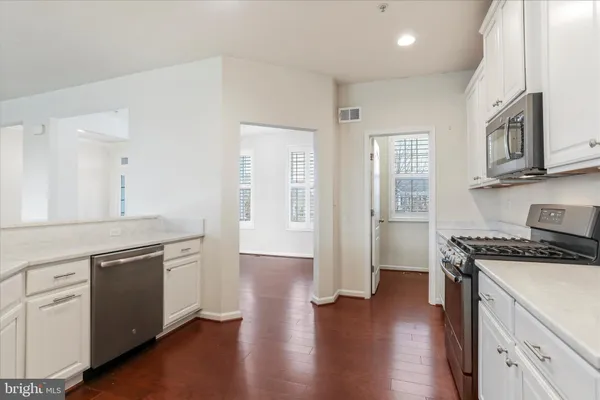 a kitchen with stainless steel appliances granite countertop a stove and a sink