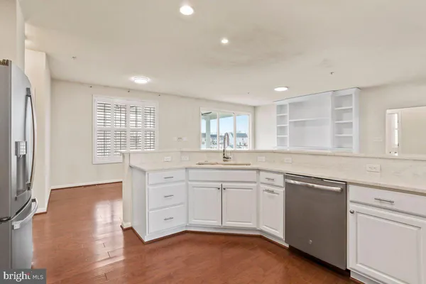a kitchen with sink cabinets and wooden floor
