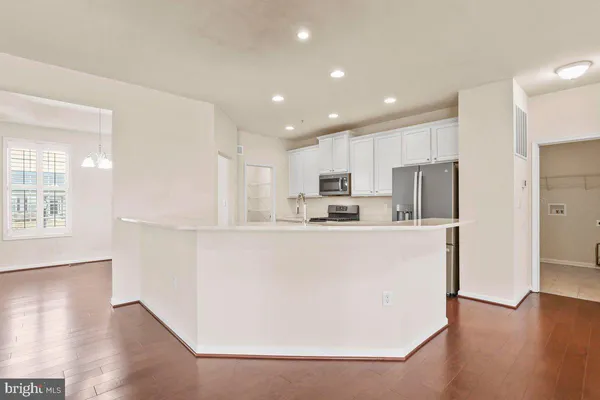 a view of kitchen with stainless steel appliances refrigerator sink and cabinets