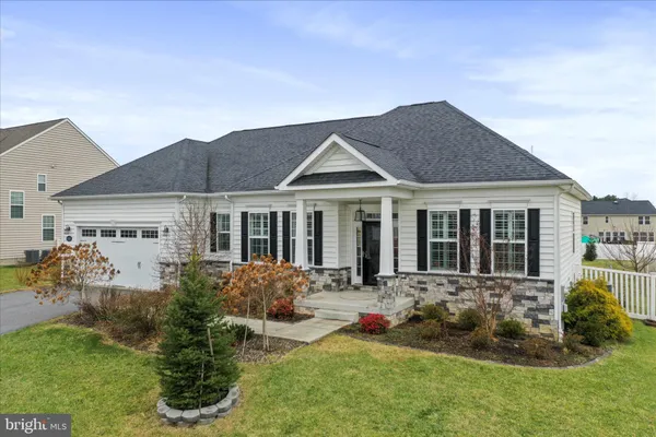 a front view of a house with a yard table and chairs