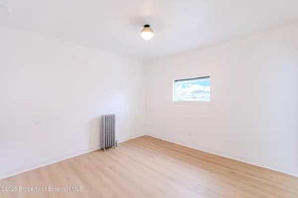 a bedroom with a bed and a night stand
