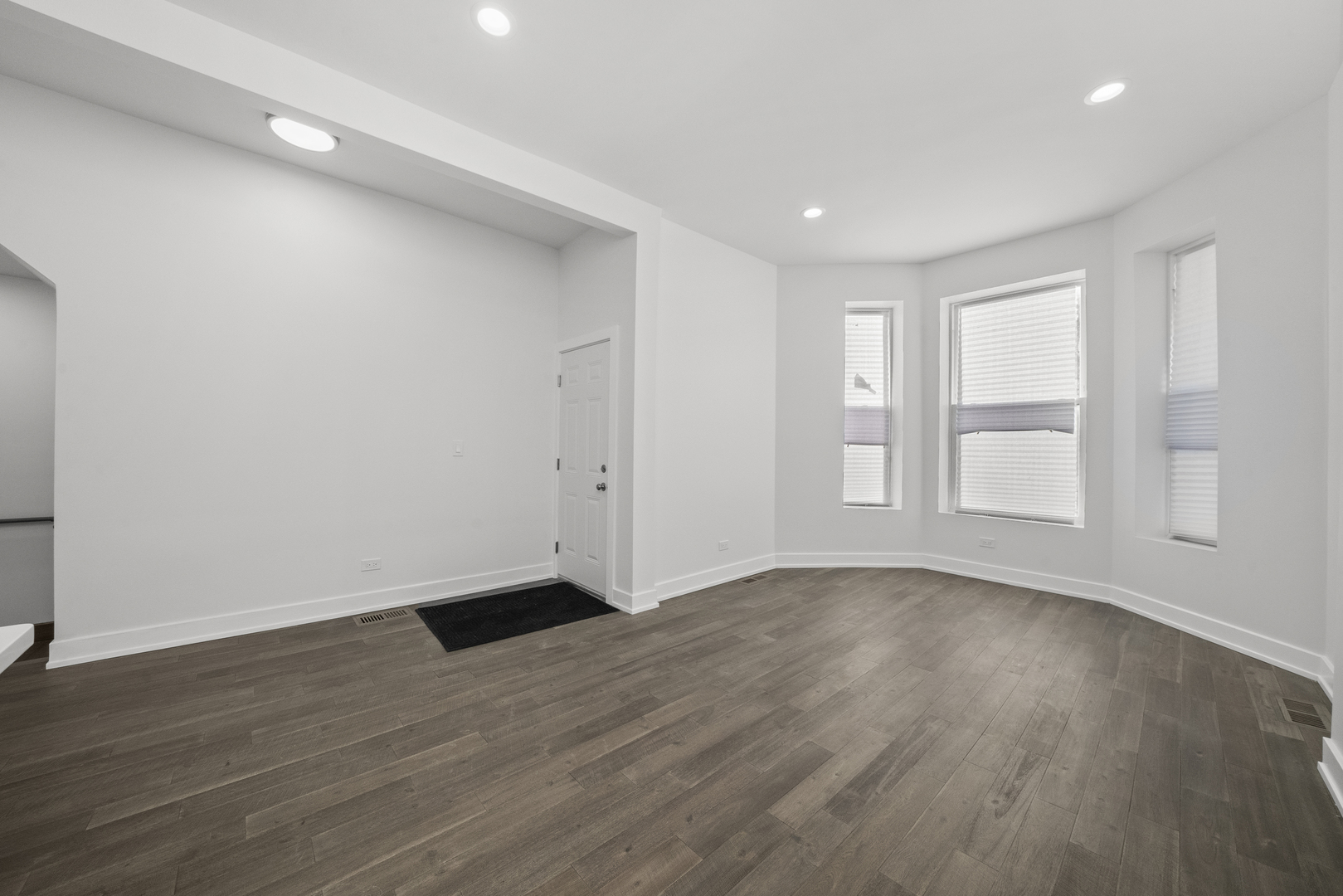 3824 West Fulton Street Chicago, IL 60624 - Photo 12 of 30 a view of an empty room with wooden floor and window