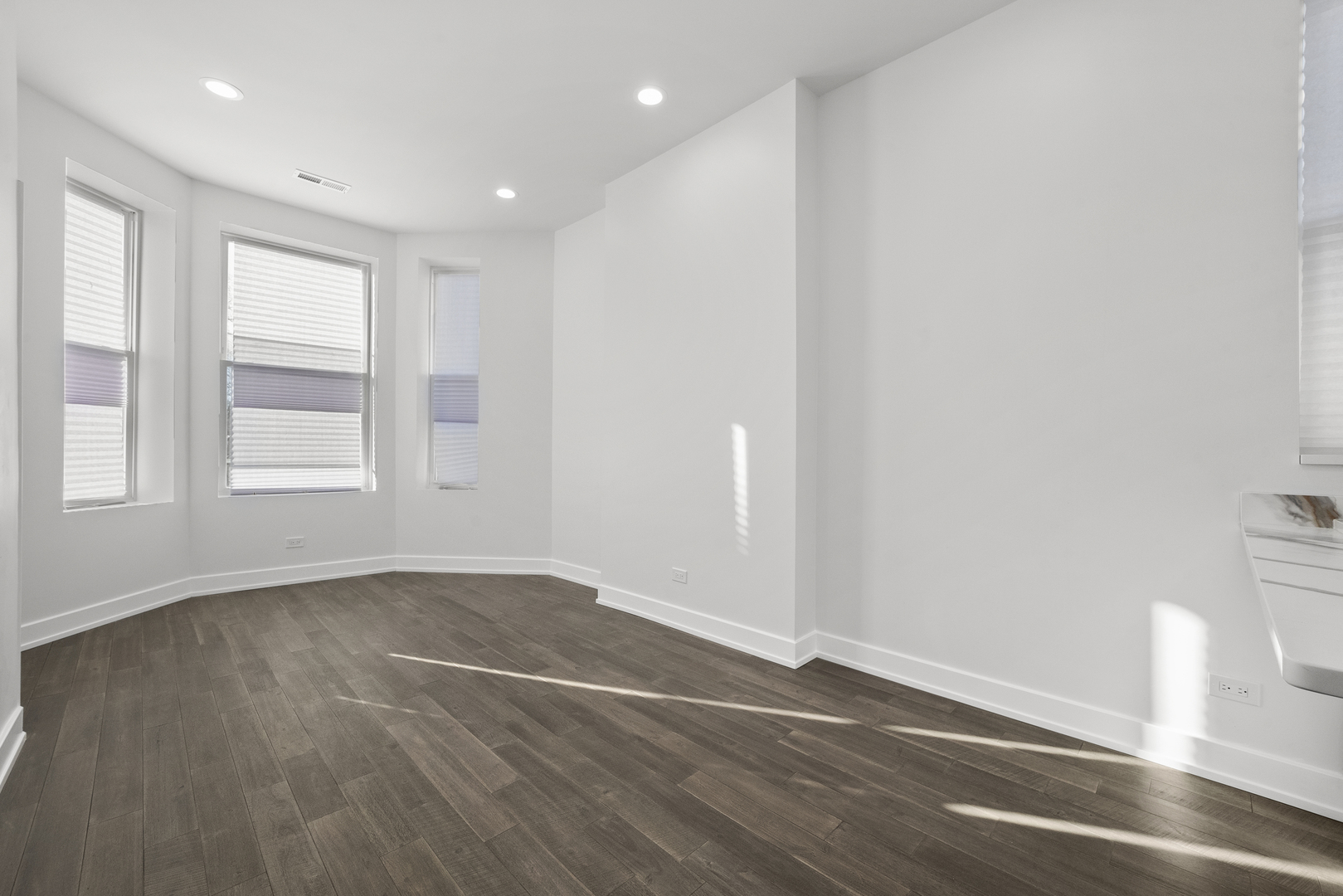 3824 West Fulton Street Chicago, IL 60624 - Photo 13 of 30 an empty room with wooden floor and windows