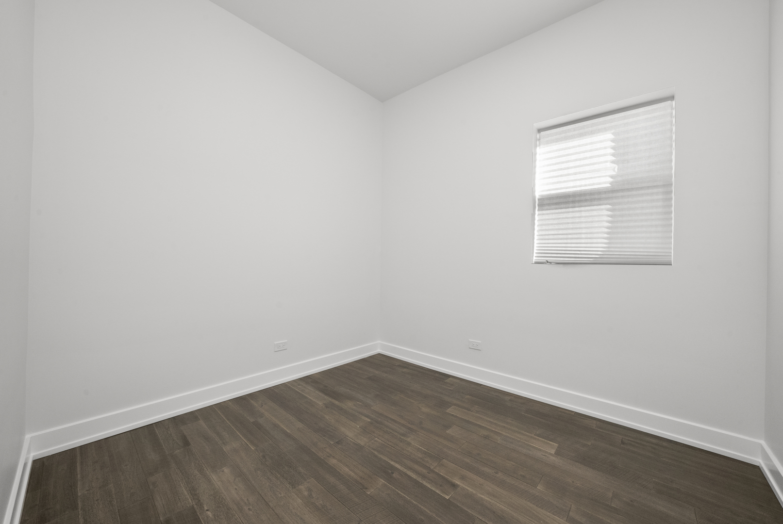 3824 West Fulton Street Chicago, IL 60624 - Photo 14 of 30 an empty room with wooden floor and windows