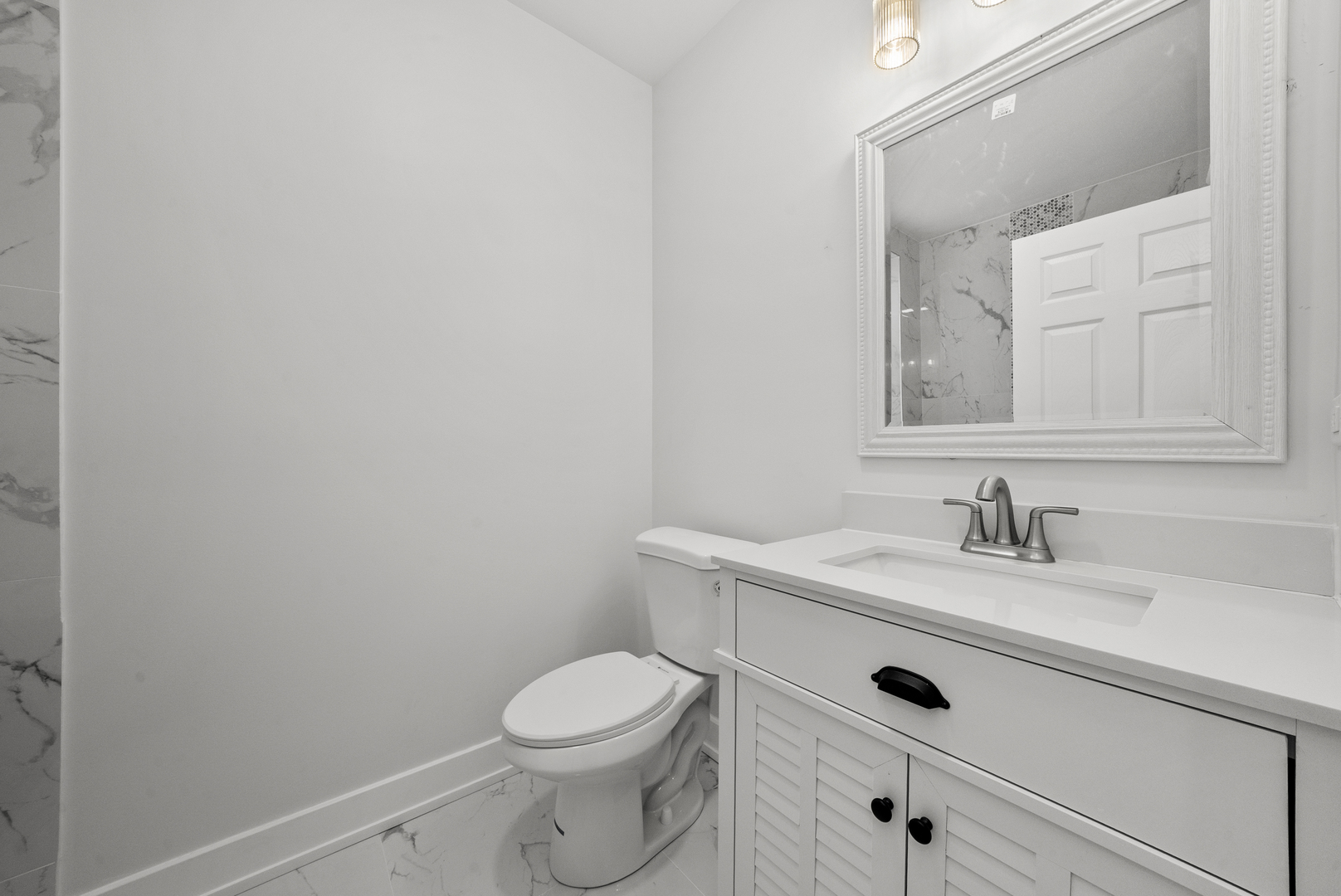 3824 West Fulton Street Chicago, IL 60624 - Photo 22 of 30 a bathroom with a granite countertop toilet sink and mirror