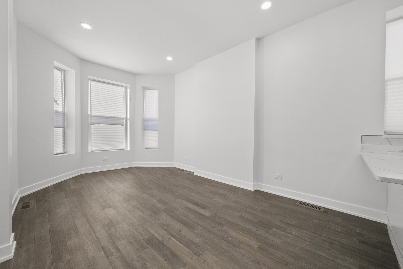 3824 West Fulton Street Chicago, IL 60624 - Photo 5 of 30 a view of an empty room with wooden floor and a window