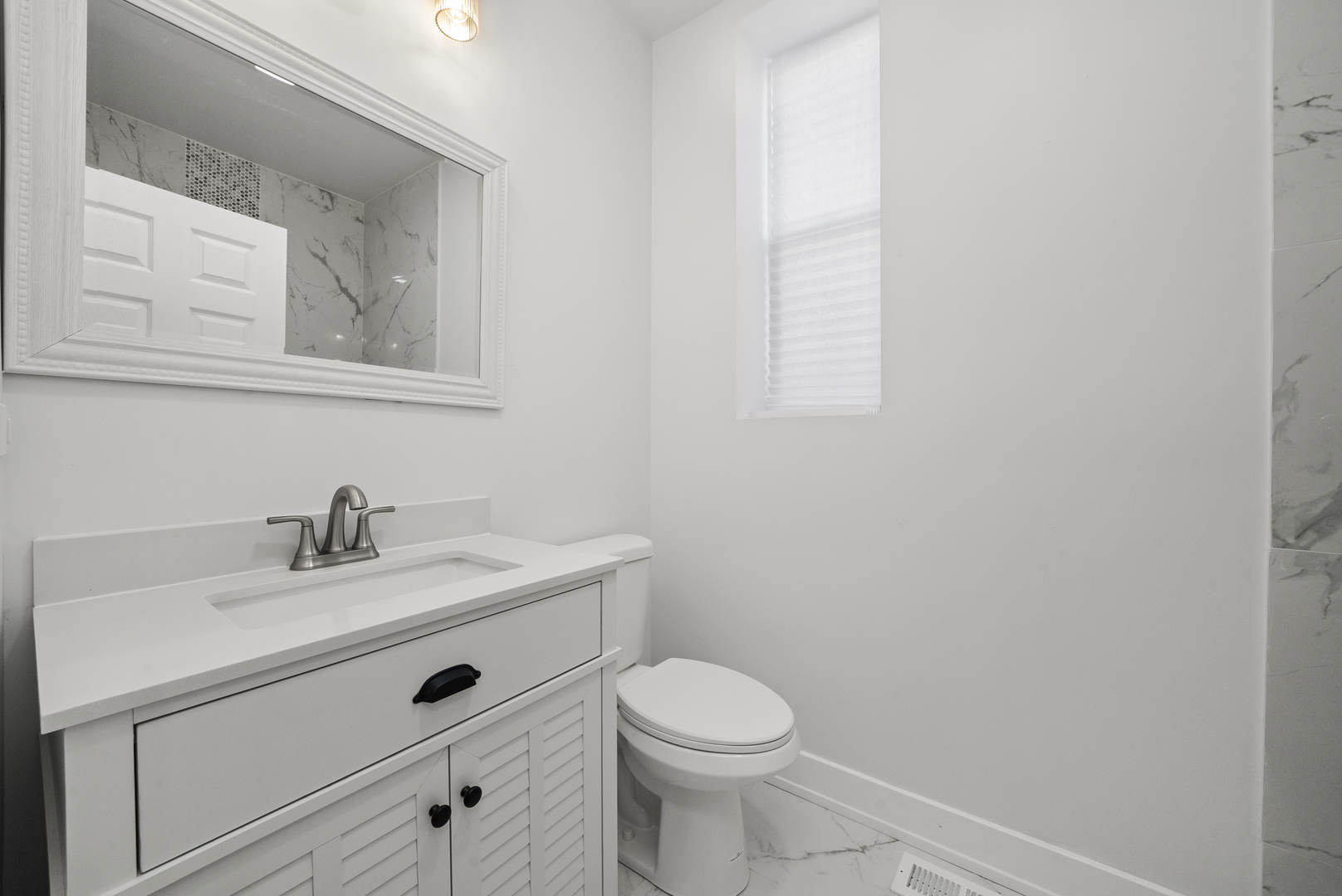 3824 West Fulton Street Chicago, IL 60624 - Photo 6 of 30 a bathroom with a sink a toilet and mirror