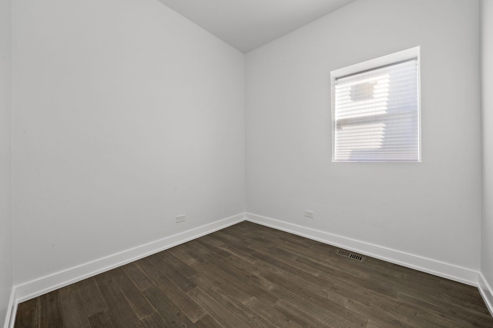 3824 West Fulton Street Chicago, IL 60624 - Photo 7 of 30 an empty room with wooden floor and a window
