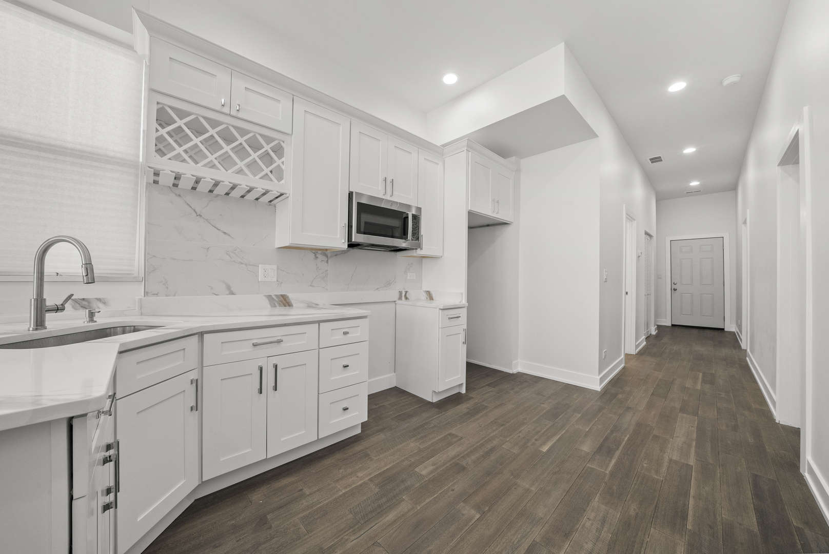 3824 West Fulton Street Chicago, IL 60624 - Photo 9 of 30 a kitchen with sink a microwave and cabinets