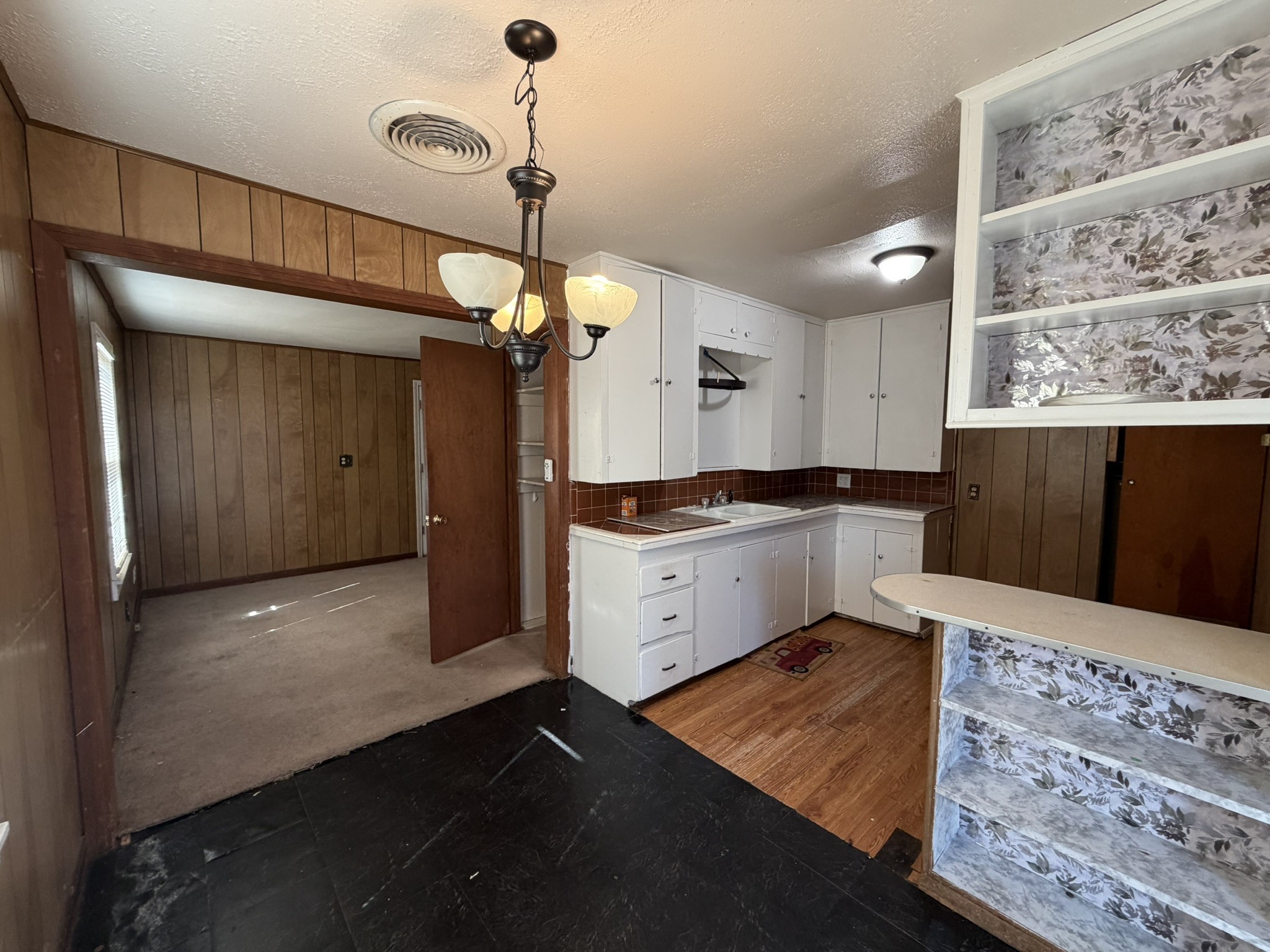813 Northwest 1st Street Andrews, TX 79714 - Photo 7 of 13 a kitchen that has a lot of cabinets in it