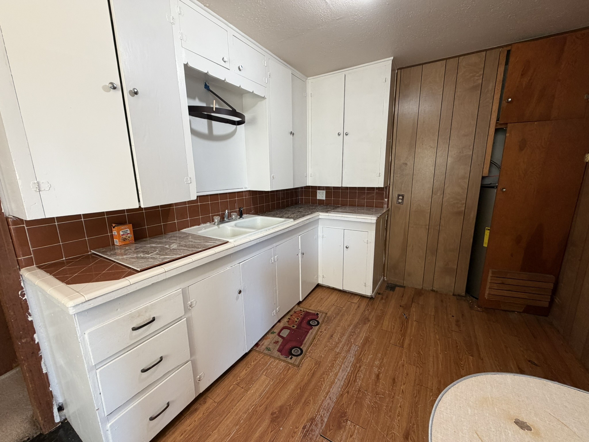 813 Northwest 1st Street Andrews, TX 79714 - Photo 8 of 13 a kitchen with a sink and wooden floor