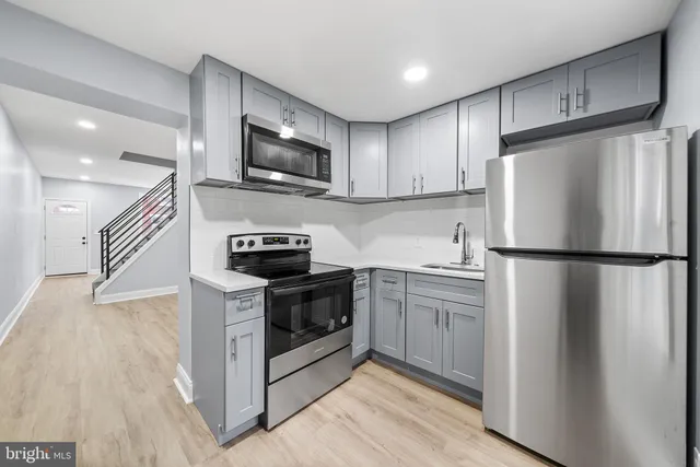 a kitchen with a refrigerator stove and microwave