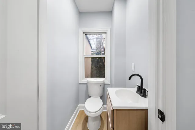 a bathroom with a toilet sink and mirror