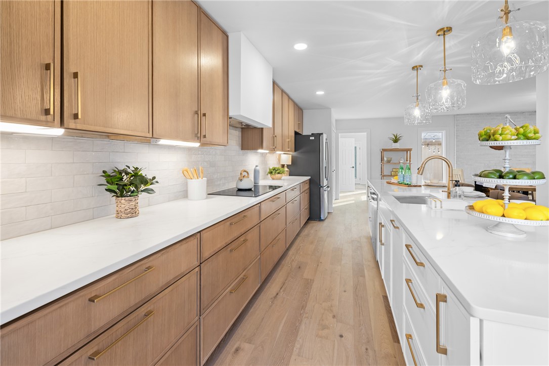 117 Riverpoint Drive Clemson, SC 29631 - Photo 18 of 47 This kitchen showcases a clean and elegant design, featuring beautiful wood flooring and thoughtful lighting.