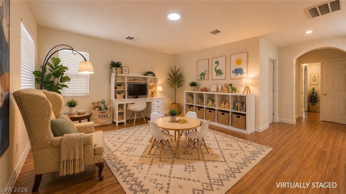 87 Tall Ruff Drive Las Vegas, NV 89148 - Photo 55 of 71 A well-lit play space with wood flooring and an arched entryway offers a dedicated area for activities.