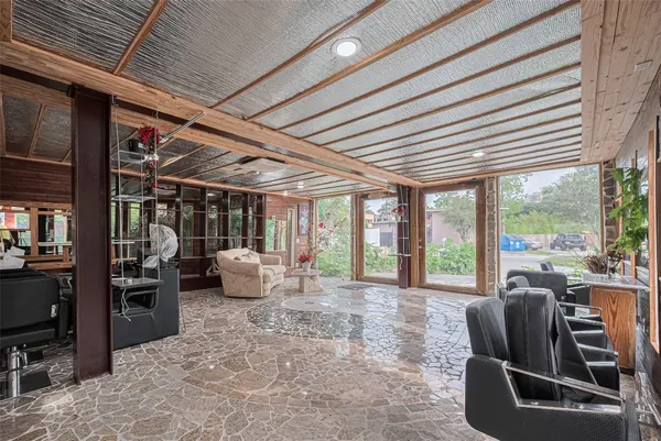 a room with furniture and large windows