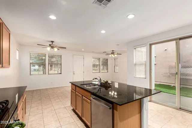 a bathroom with a granite countertop sink a large mirror and a bathtub