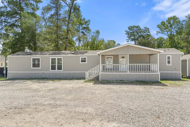 a view of a house with a yard and a garden