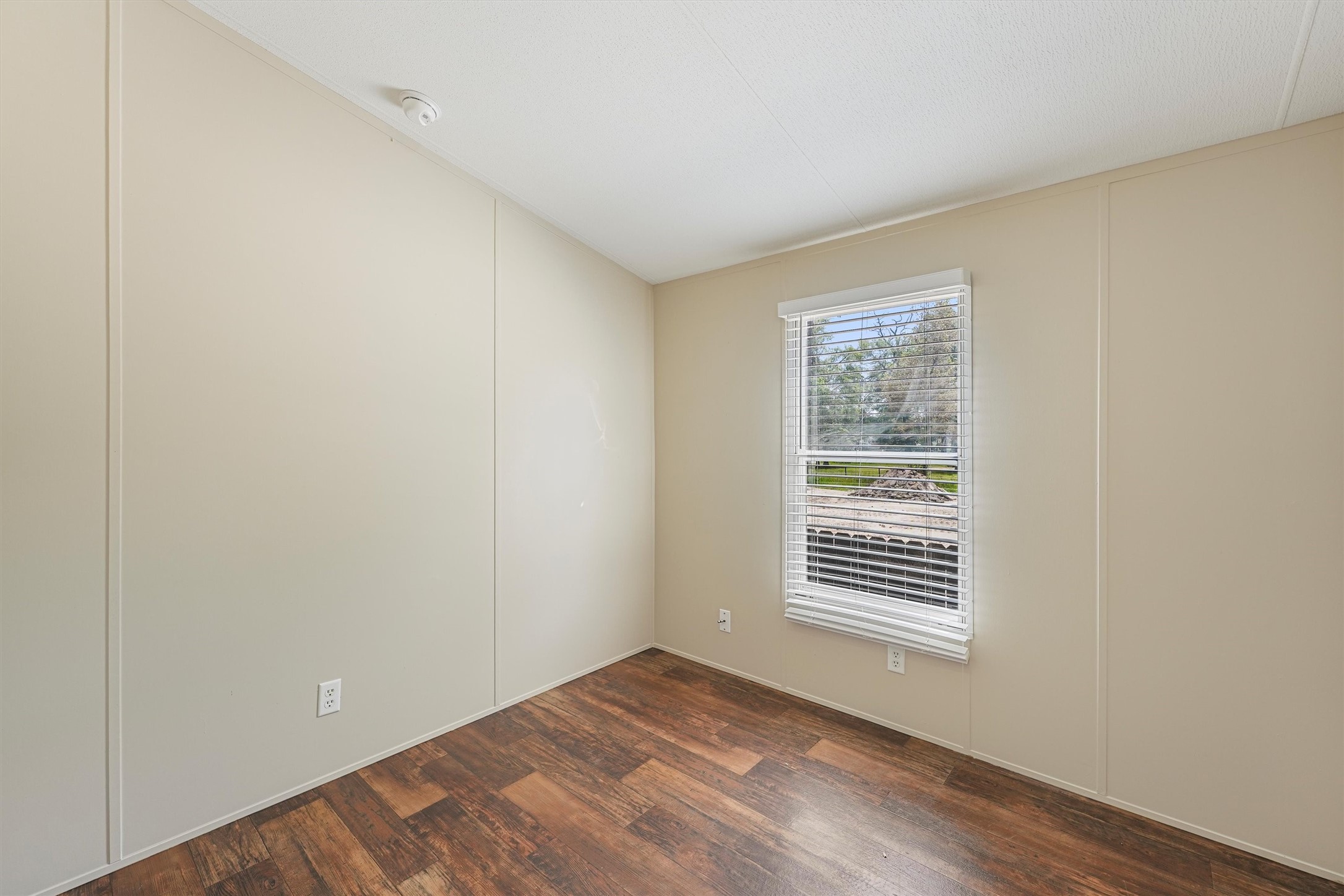 21864 Russell Drive New Caney, TX 77357 - Photo 11 of 15 a view of an empty room with wooden floor and a window