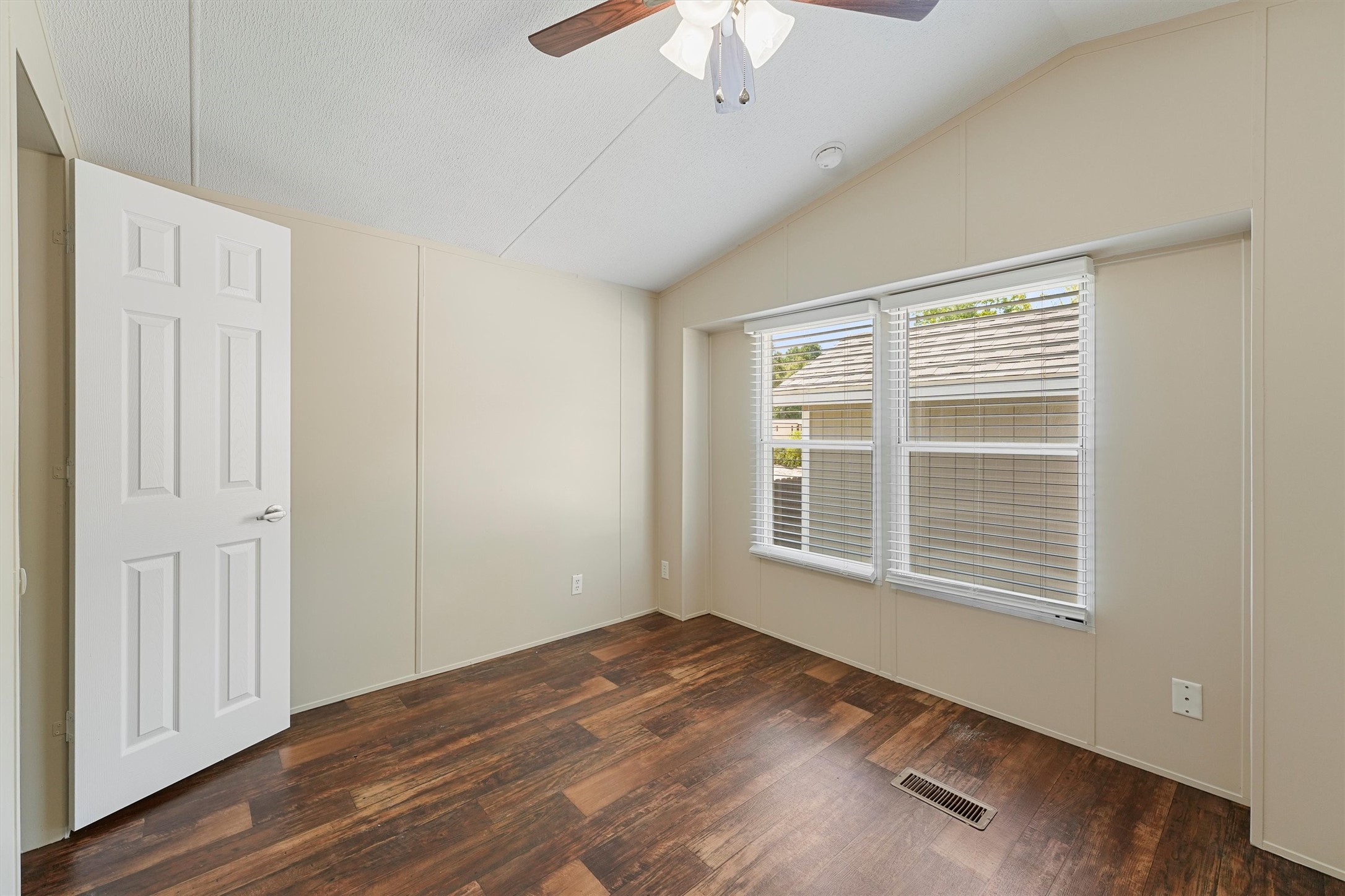 21864 Russell Drive New Caney, TX 77357 - Photo 12 of 15 a view of an empty room with wooden floor and a window