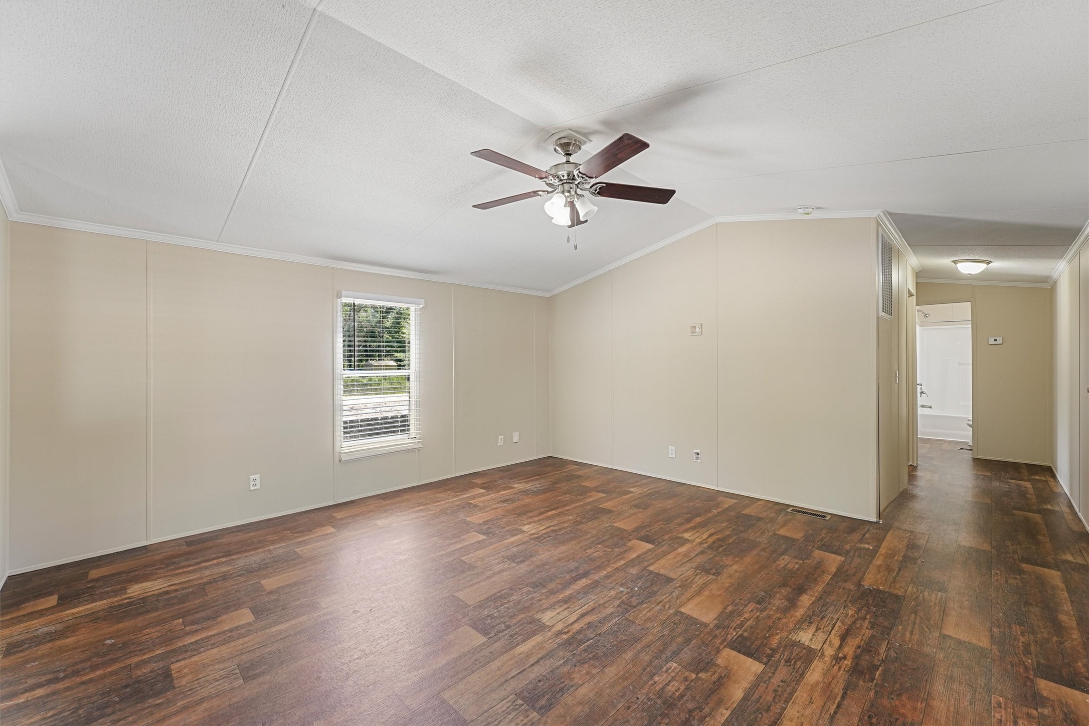 21864 Russell Drive New Caney, TX 77357 - Photo 13 of 15 a view of empty room with wooden floor and fan