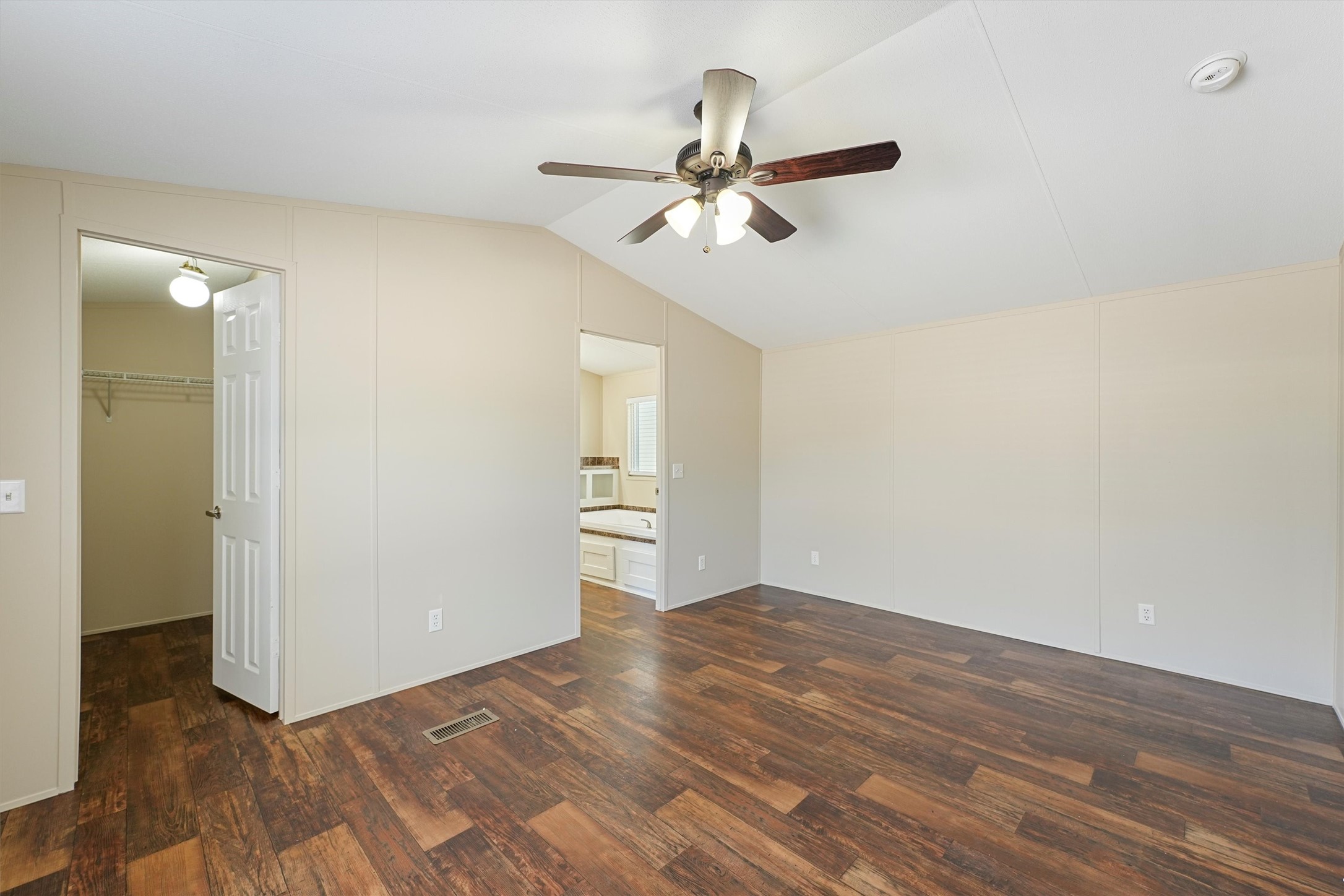 21864 Russell Drive New Caney, TX 77357 - Photo 10 of 15 a view of a room with wooden floor and ceiling fan