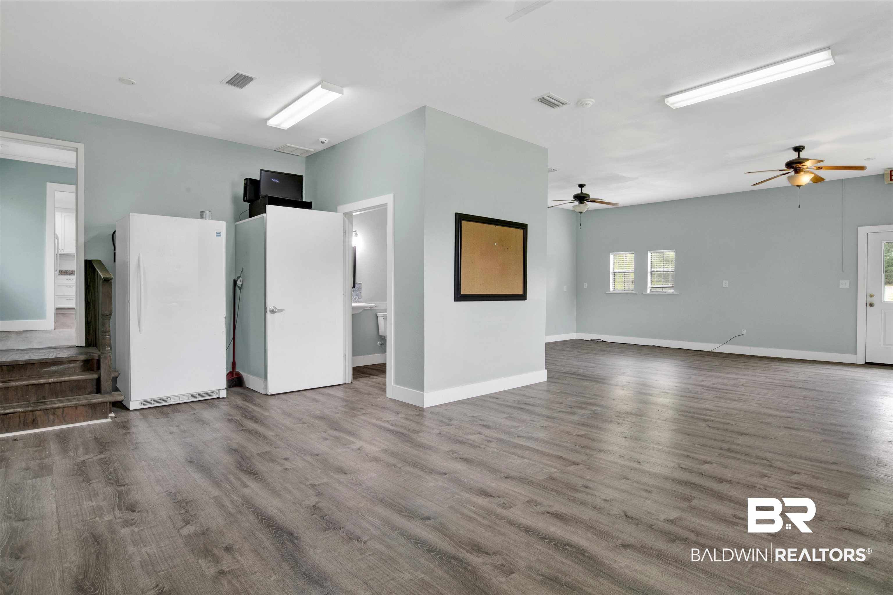 17714 Horseneck Road Bay Minette, AL 36507 - Photo 12 of 36 Spacious multi-purpose room featuring wood-finish flooring, light blue walls, multiple ceiling fans, and recessed lighting