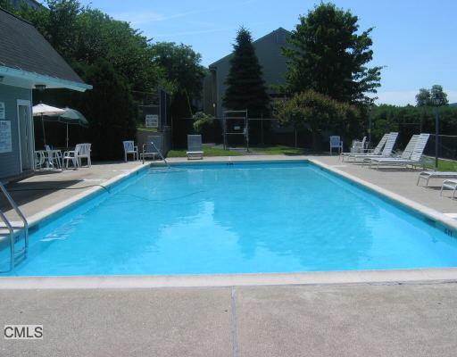 55 Mill Plain Road, Unit 309 Danbury, CT 06811 - Photo 1 of 1 a view of a swimming pool with a patio