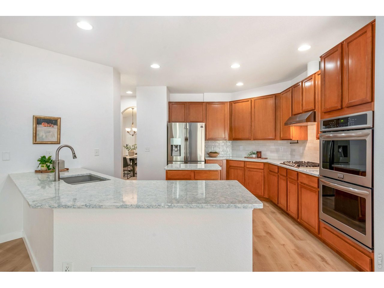 5574 Quarry Street Timnath, CO 80547 - Photo 11 of 43 a kitchen with stainless steel appliances granite countertop a stove a sink and a refrigerator