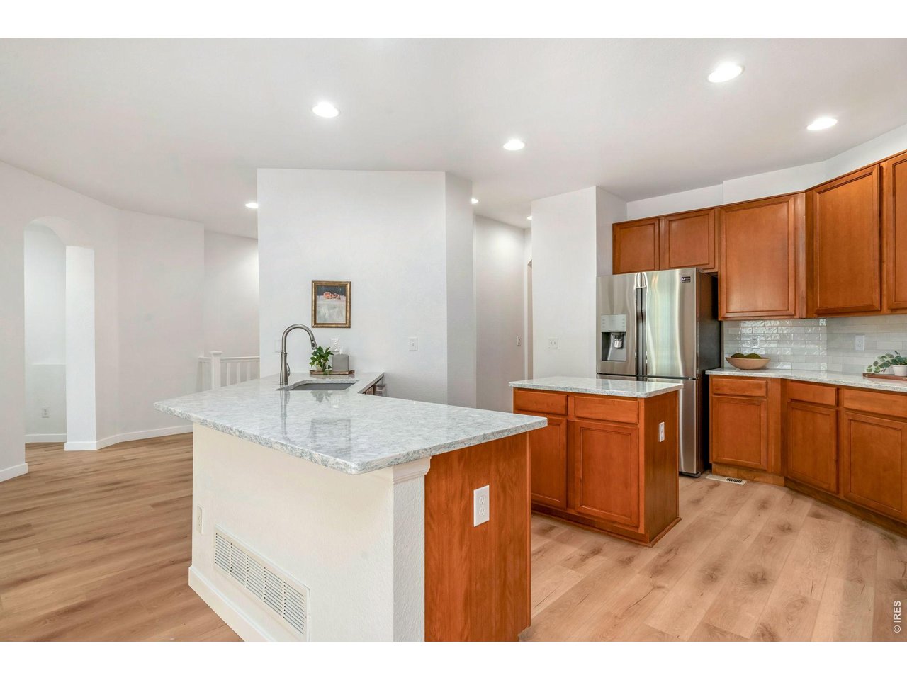 5574 Quarry Street Timnath, CO 80547 - Photo 12 of 43 a kitchen with stainless steel appliances granite countertop a sink refrigerator and cabinets