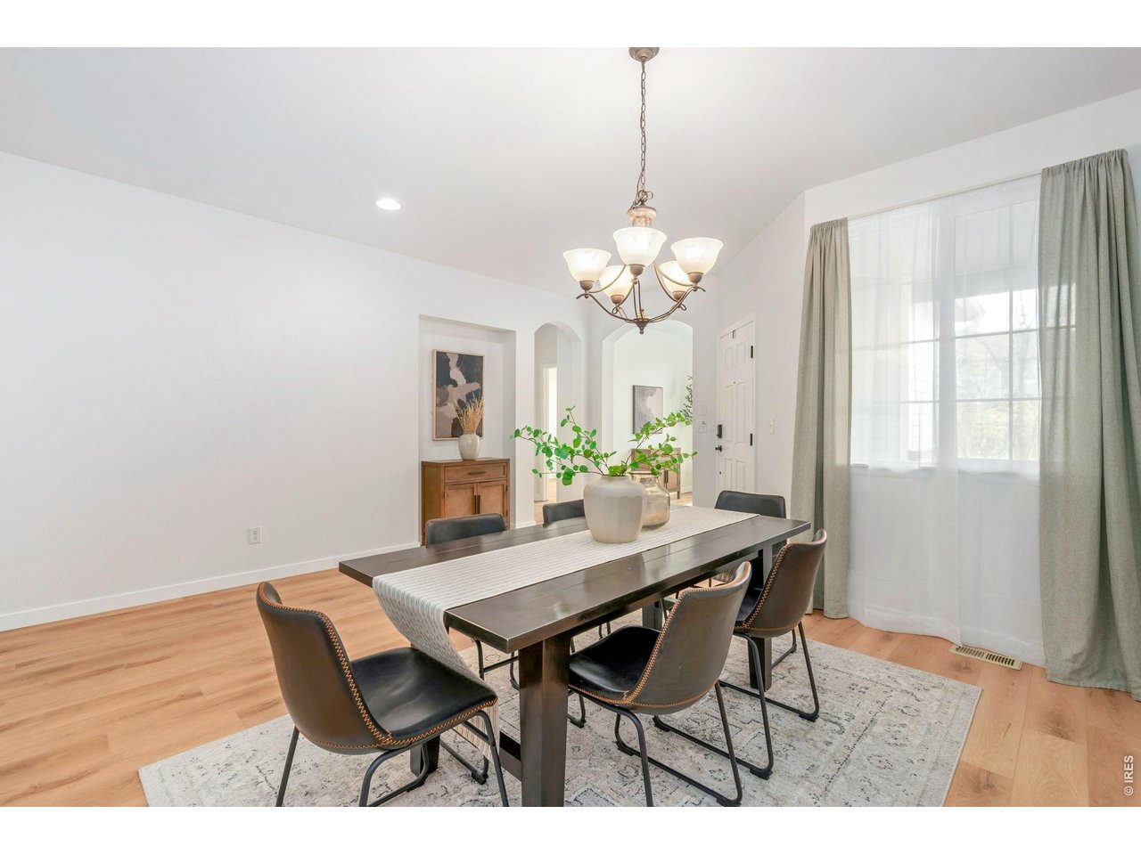 5574 Quarry Street Timnath, CO 80547 - Photo 16 of 43 a view of a dining room with furniture and chandelier