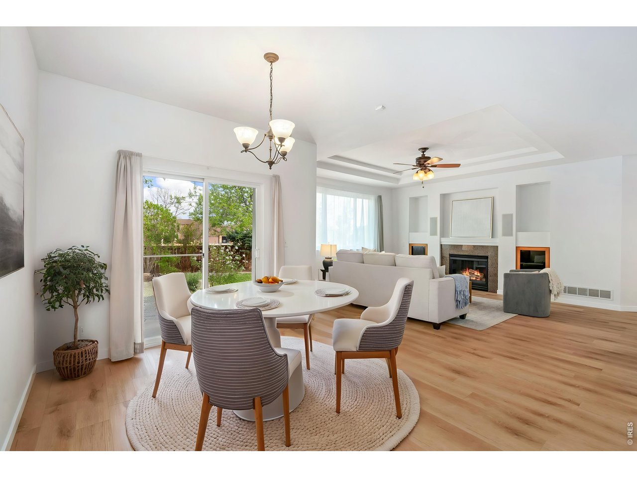 5574 Quarry Street Timnath, CO 80547 - Photo 18 of 43 a view of a dining room with furniture wooden floor and chandelier