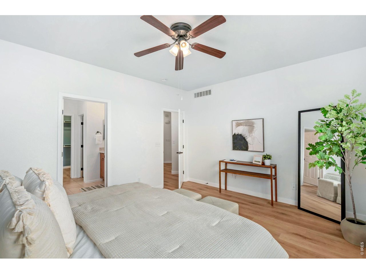 5574 Quarry Street Timnath, CO 80547 - Photo 20 of 43 a bedroom with furniture and a potted plant